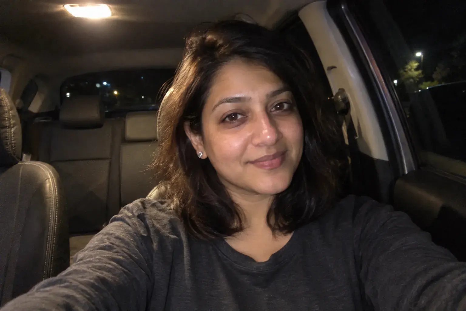 Selfie of a woman taken in a car at night