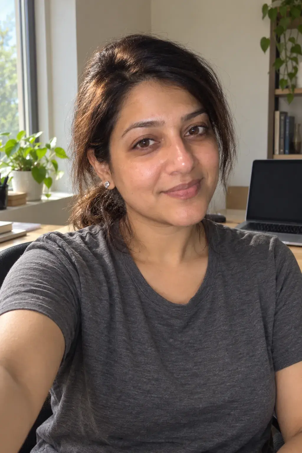 Casual selfie of a woman at her desk at home